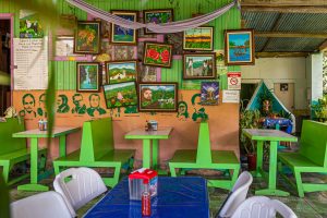 Restaurant in Costa Rica with naive paintings and stenciled portraits of South American politicians